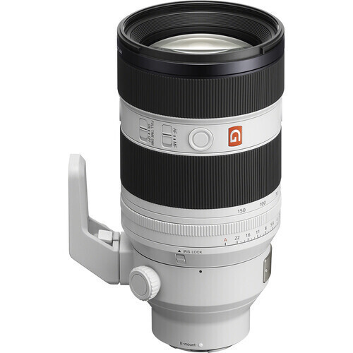Telephoto zoom lens with tripod collar and white body, shown from the side with black focusing rings