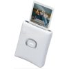 White Instax instant photo printer with a photo being ejected of three people on a couch.
