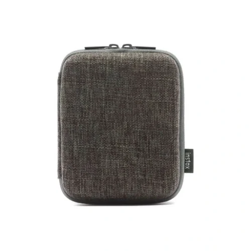 Small dark gray fabric zippered case with rounded edges and a side brand tag.
