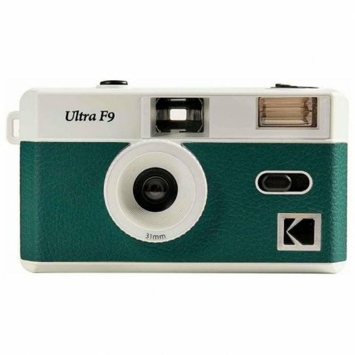 Vintage teal and white 35mm camera with a large central lens and built-in flash on the top right corner