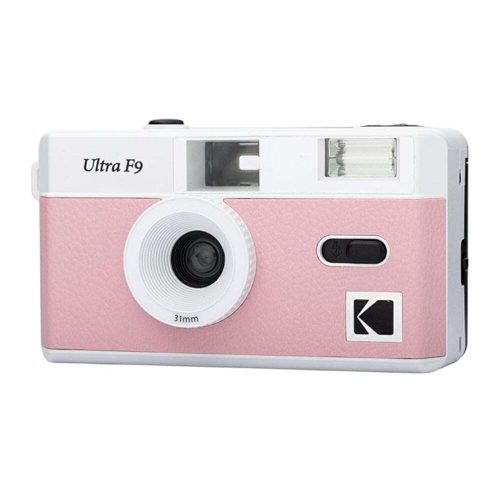 Pink and white retro-style compact camera with a prominent center lens and flash on top.