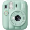 Mint green Instax Mini 13 instant camera facing forward, showing lens, flash, and control dial.