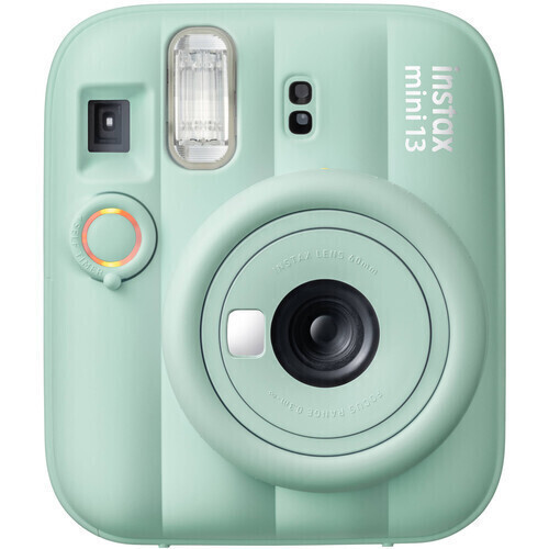 Mint green Instax Mini 13 instant camera facing forward, showing lens, flash, and control dial.