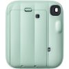 Mint green compact camera viewed from the back, showing the lens housing in the top-right corner and a hinged panel in the center.
