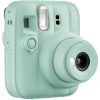 Mint-green Instax Mini 13 instant camera with lens extended and flash above the lens