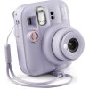 Lavender Instax Mini 13 instant camera with built-in lens, flash, and wrist strap visible.