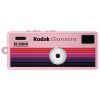 Pink Kodak Charmera Millennium toy camera with rainbow stripe design and central lens.