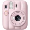 Front view of a pastel pink Instax Mini 13 instant camera, showing the lens, flash, and cartridge ring on the side.