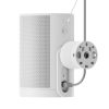 White cylindrical smart speaker with a perforated front and a large round power adapter mounted on its side.