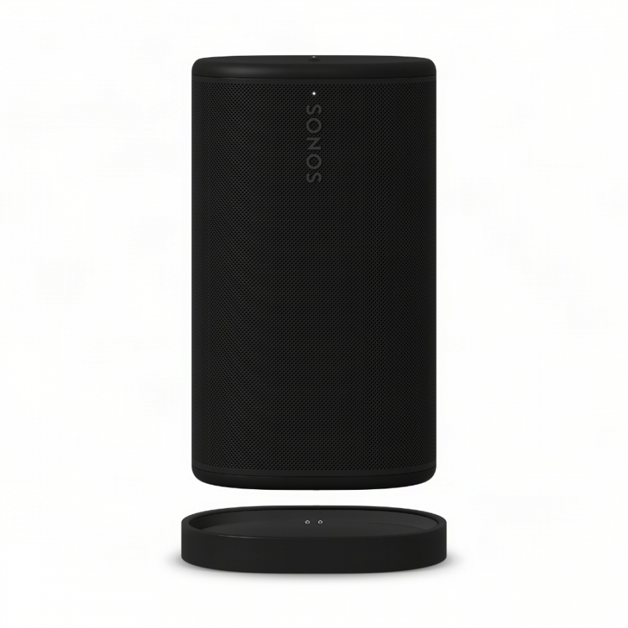 37128_1-900x900 | Kounio.gr Black cylindrical Sonos wireless speaker with perforated grille, standing next to its round charging dock on a white background.