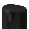 Black cylindrical portable speaker with mesh sides and a fabric strap hinge on the side, top controls visible (volume and power).” ,