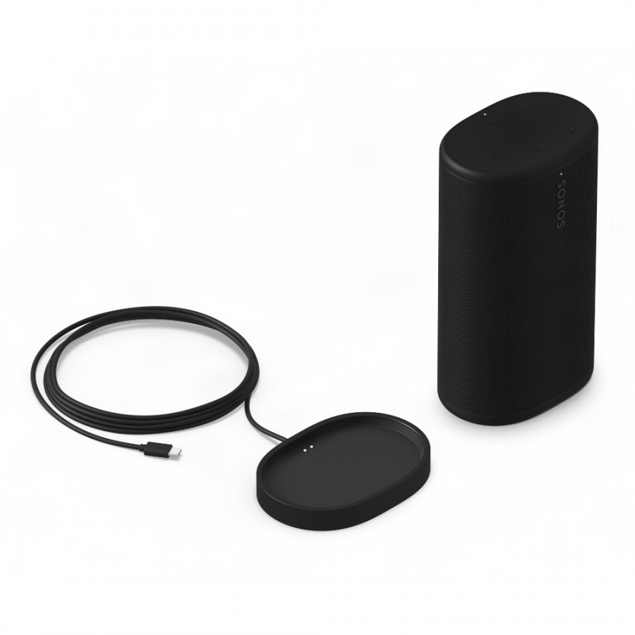37128_13-900x900 | Kounio.gr Black Sonos portable speaker with its oval charging dock and cable on a white surface.