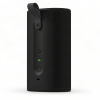 Black cylindrical portable speaker with a fold-out handle, perforated grille on the right, and front-side USB-C/port area with a green indicator light and power button