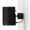 Black cylindrical speaker mounted to the wall with a round wall bracket and visible cable.