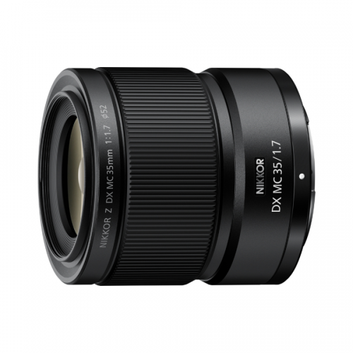 Close-up of a black Nikon DX 35mm f/1.7 lens, showing the knurled focus ring and front element
