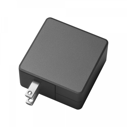 Black cube-shaped mains power adapter with two flat-prong plug protruding from the side.