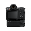 Rear view of a black DSLR-style camera with a large LCD screen and multiple control buttons on the right side, and a textured grip on the right edge