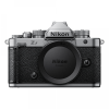 Front view of a Nikon Z mount mirrorless camera body with lens cap on, showing textured grip and control dials on top.