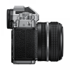 Side view of a silver and black camera with a textured grip and a large attached zoom lens