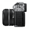 Side view of a compact digital camera with a zoom lens, grey body, textured grip, and visible HDMI and MIC port panels on the side.