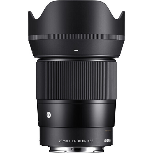 Front view of a black Sigma 23mm f/1.4 DC DN camera lens with a petal-shaped hood.
