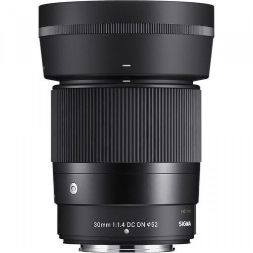 Sigma 30mm f/1.4 DC DN lens for mirrorless cameras, black with textured grip visible in the midsection and front element cap edge.