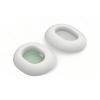 Pair of white donut-shaped cushions with hollow centers; one shows green interior fabric with a small slit, the other a gray mesh inset.