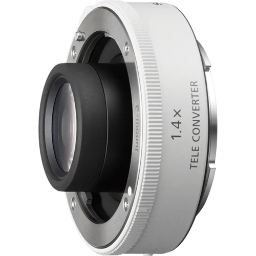 Close-up of a silver camera lens mount with a 1.4x teleconverter attached, showing the mounting ring and glass element inside