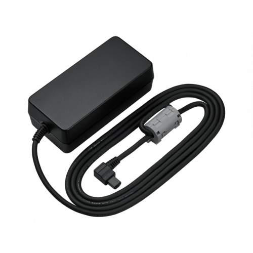 Laptop power adapter with a black rectangular brick and a coiled cable ending in a DC connector, shown on a dark background.