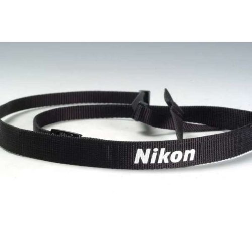 Black Nikon camera strap lying in a loop on a white surface with the white Nikon logo visible on the strap edge.