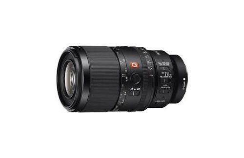 Close-up of a black zoom camera lens with a visible orange 'G' badge and front element showing, mounted on a white background.