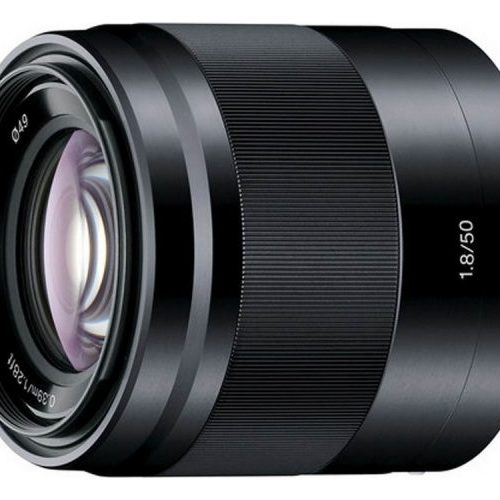 Close-up of a black 50mm f/1.8 camera lens, showing the front glass element and markings.